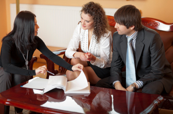 couple sitting with mortgage professional